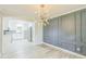 Stylish dining room featuring modern lighting, paneled accent wall, neutral walls, and view of updated kitchen at 2300 Radius Cir, Sanford, NC 27330