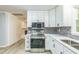 Well lit kitchen with stainless appliances, gray backsplash, and white cabinets at 2300 Radius Cir, Sanford, NC 27330