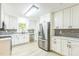 Bright kitchen with stainless appliances, white cabinets and gray tile backsplash at 2300 Radius Cir, Sanford, NC 27330