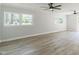 Bright living room featuring wood-look floors, modern ceiling fans, and light gray walls at 2300 Radius Cir, Sanford, NC 27330