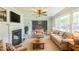 Comfortable living room featuring fireplace, wood flooring, furniture, and bright natural light at 2300 Radius Cir, Sanford, NC 27330