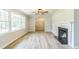 Bright and airy living room featuring neutral walls, fireplace, decorative light fixture, and lots of natural light at 2300 Radius Cir, Sanford, NC 27330