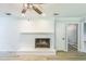 Living room features a white-painted brick fireplace, light walls, and wood-look floors at 2300 Radius Cir, Sanford, NC 27330