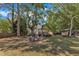 Inviting backyard features a fire pit and mature trees, perfect for outdoor entertaining at 24 W Canterbury Ct, Wendell, NC 27591