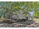 Spacious backyard featuring a covered patio area, mature trees, and landscaping at 24 W Canterbury Ct, Wendell, NC 27591