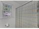 Cozy bathroom featuring a shower with patterned curtain and a window allowing natural light at 24 W Canterbury Ct, Wendell, NC 27591