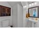 Cozy half bathroom with a pedestal sink and vintage-style cabinet at 24 W Canterbury Ct, Wendell, NC 27591