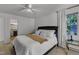 Bright bedroom features a ceiling fan, two windows, and ensuite bath at 24 W Canterbury Ct, Wendell, NC 27591