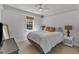 Bedroom with ceiling fan features a large window and neutral decor at 24 W Canterbury Ct, Wendell, NC 27591