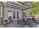 Covered patio featuring an outdoor dining table and chairs for entertaining guests at 24 W Canterbury Ct, Wendell, NC 27591