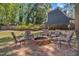 Backyard brick fire pit surrounded by comfortable seating, ideal for relaxing evenings at 24 W Canterbury Ct, Wendell, NC 27591