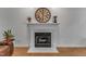 Elegant fireplace with white mantel, marble surround, and classic clock above at 24 W Canterbury Ct, Wendell, NC 27591