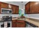 Close up view of the kitchen with wooden cabinets and stainless steel appliances at 24 W Canterbury Ct, Wendell, NC 27591