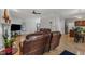 Open-concept living area with hardwood floors, a fireplace, and views into the kitchen at 24 W Canterbury Ct, Wendell, NC 27591