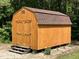 New, sturdy barn with brown shingles and double door storage in a wooded area at 2483 Mcneill Hobbs Rd, Bunnlevel, NC 28323