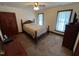 Cozy bedroom featuring carpet floors, two windows, and warm neutral tones at 2483 Mcneill Hobbs Rd, Bunnlevel, NC 28323