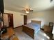 Bright bedroom with neutral walls, ceiling fan, and rustic sliding barn door at 2483 Mcneill Hobbs Rd, Bunnlevel, NC 28323