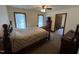 Cozy bedroom featuring carpet floors, two windows, and warm neutral tones at 2483 Mcneill Hobbs Rd, Bunnlevel, NC 28323