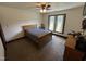 Well-lit bedroom features neutral walls, ceiling fan, and window with views at 2483 Mcneill Hobbs Rd, Bunnlevel, NC 28323