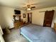Comfortable bedroom with rustic furniture, ceiling fan, and sliding barn door at 2483 Mcneill Hobbs Rd, Bunnlevel, NC 28323