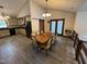 Bright dining area with tile floors next to a kitchen with black appliances and modern cabinetry at 2483 Mcneill Hobbs Rd, Bunnlevel, NC 28323