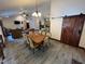 Open-concept dining area with tile floors, connecting the kitchen and living spaces at 2483 Mcneill Hobbs Rd, Bunnlevel, NC 28323