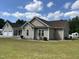 Tan vinyl-sided ranch home with brown shingle roof at 2483 Mcneill Hobbs Rd, Bunnlevel, NC 28323