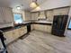 Charming kitchen featuring modern appliances, light cabinetry and beautiful tile flooring at 2483 Mcneill Hobbs Rd, Bunnlevel, NC 28323