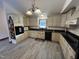 Charming kitchen featuring modern appliances, light cabinetry, and beautiful tile flooring at 2483 Mcneill Hobbs Rd, Bunnlevel, NC 28323