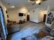 Well-lit living room showing open floor plan, tile floors and vaulted ceiling at 2483 Mcneill Hobbs Rd, Bunnlevel, NC 28323
