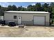 A large, steel outbuilding with a roll up door for storing equipment or vehicles at 2483 Mcneill Hobbs Rd, Bunnlevel, NC 28323