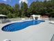 Backyard pool with a charming waterfall feature, white picket fence and plenty of space at 2483 Mcneill Hobbs Rd, Bunnlevel, NC 28323
