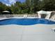 Backyard pool with a waterfall feature and pristine deck and lounge chairs for relaxing outdoor enjoyment at 2483 Mcneill Hobbs Rd, Bunnlevel, NC 28323