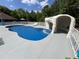 Backyard pool with a rock waterfall feature and lounge area for ultimate relaxation and entertainment at 2483 Mcneill Hobbs Rd, Bunnlevel, NC 28323