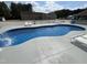 Well-maintained pool surrounded by a spacious patio and a white picket fence at 2483 Mcneill Hobbs Rd, Bunnlevel, NC 28323