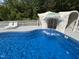 Waterfall feature cascading into the pool, creating a serene and luxurious backyard retreat at 2483 Mcneill Hobbs Rd, Bunnlevel, NC 28323