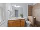 Bright bathroom featuring a vanity, toilet, and tiled shower at 2536 Bent Green St, Raleigh, NC 27614
