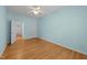Bright bedroom with a ceiling fan, light blue walls, and light wood flooring at 2536 Bent Green St, Raleigh, NC 27614