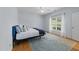 Cozy bedroom with a ceiling fan and large windows overlooking the backyard at 2536 Bent Green St, Raleigh, NC 27614