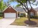 Charming home with a brick and siding exterior, well-manicured lawn, and a two-car garage at 2536 Bent Green St, Raleigh, NC 27614