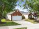 Charming home with a brick and siding exterior, well-manicured lawn, and a two-car garage at 2536 Bent Green St, Raleigh, NC 27614