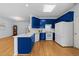 Bright kitchen featuring blue cabinetry, white countertops, and stainless steel appliances at 2536 Bent Green St, Raleigh, NC 27614