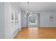 Spacious living room with hardwood floors, decorative lighting, and large windows with curtains at 2536 Bent Green St, Raleigh, NC 27614