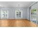 Spacious living room with hardwood floors, decorative lighting, and large windows with curtains at 2536 Bent Green St, Raleigh, NC 27614