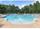 Large community pool with lounge chairs and umbrellas at 2536 Bent Green St, Raleigh, NC 27614