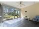 Relaxing screened porch with tile floor, a ceiling fan, and views of the landscaped backyard at 2536 Bent Green St, Raleigh, NC 27614