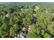 Aerial view of a residential neighborhood with lush trees and a golf course nearby at 266 Hogans Valley Way, Cary, NC 27513