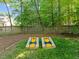 Large backyard featuring a cornhole game setup on lush, green grass at 266 Hogans Valley Way, Cary, NC 27513