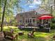 Extensive backyard with a patio, fire pit, mature trees, and manicured lawn at 266 Hogans Valley Way, Cary, NC 27513