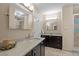 Beautiful bathroom with dual granite vanities, dark wood cabinets, and tile flooring at 266 Hogans Valley Way, Cary, NC 27513